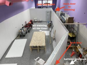 aerial view of training room with indications of main entrance, hall through area and doors to training room