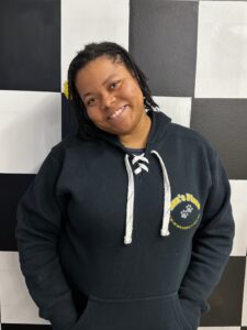 Jeneen in front of a checkerboard wall